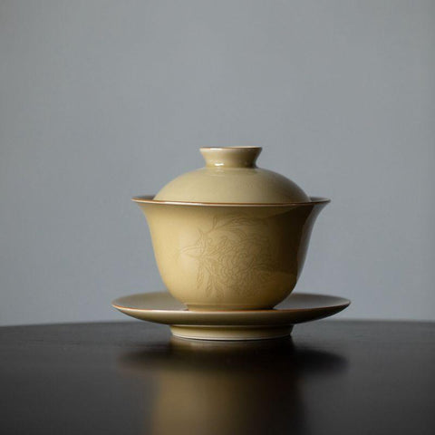 Imitation Ding Kiln Yellow Gaiwan with Floral Engraving Imitation Ding Kiln Yellow Gaiwan with Floral Engraving