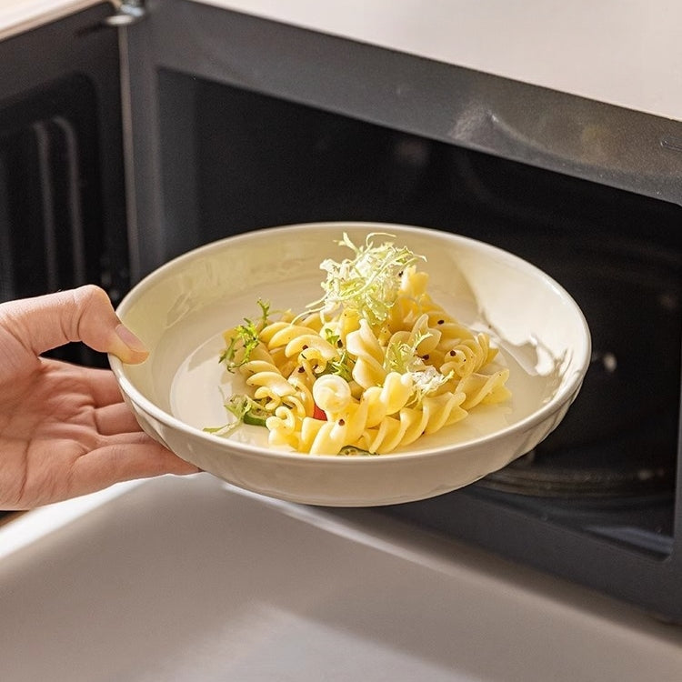 Cream ceramic dinner plate with hand-pressed texture and deepened rim design